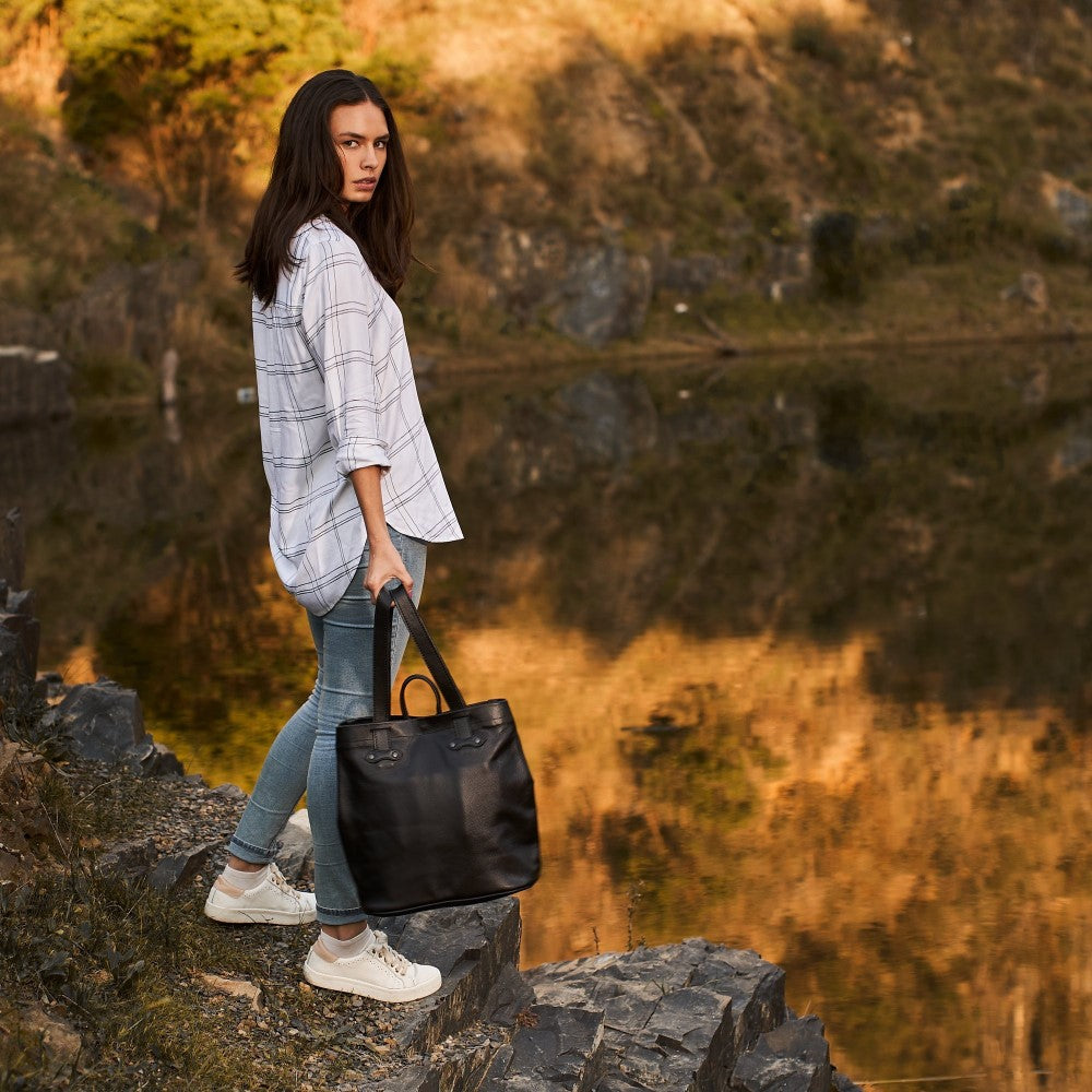 Woman standing with Haley Backpack-Black in her hand
