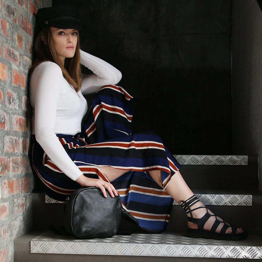 Woman with Medium Ellie Sling Bag - Black