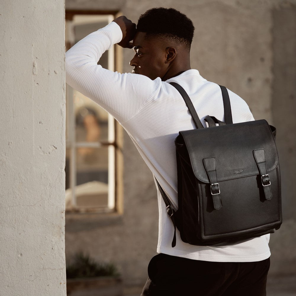 Man carries Peyton 15" Laptop Backpack - Black on his back