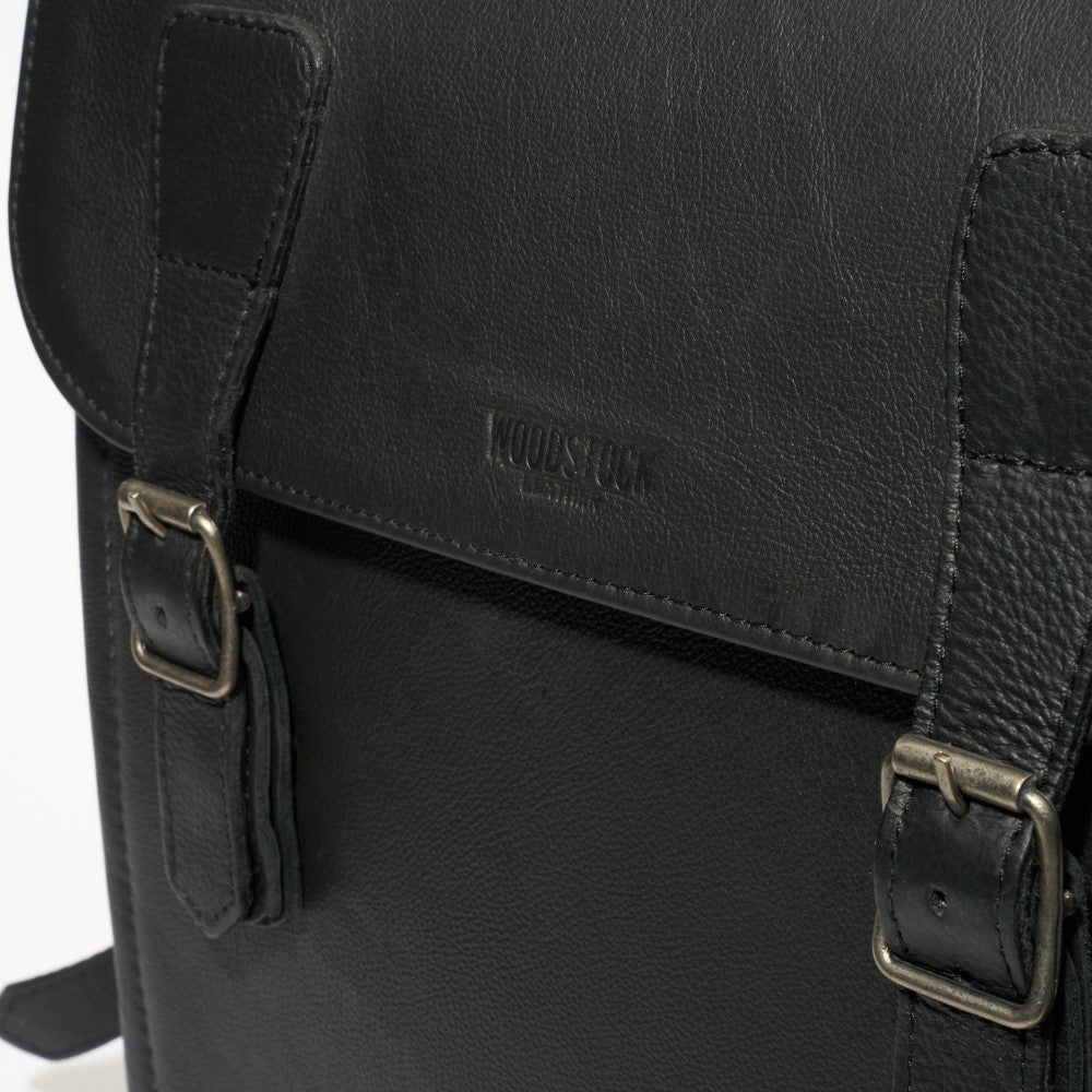 Front view of buckle closure and strap on Peyton 15" Laptop Backpack - Black