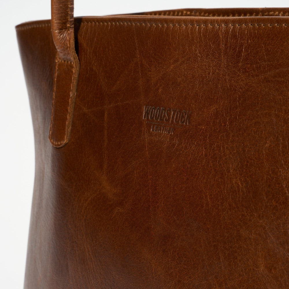 Front view of embossed Woodstock Leather logo on Blake Tote Bag - Pecan