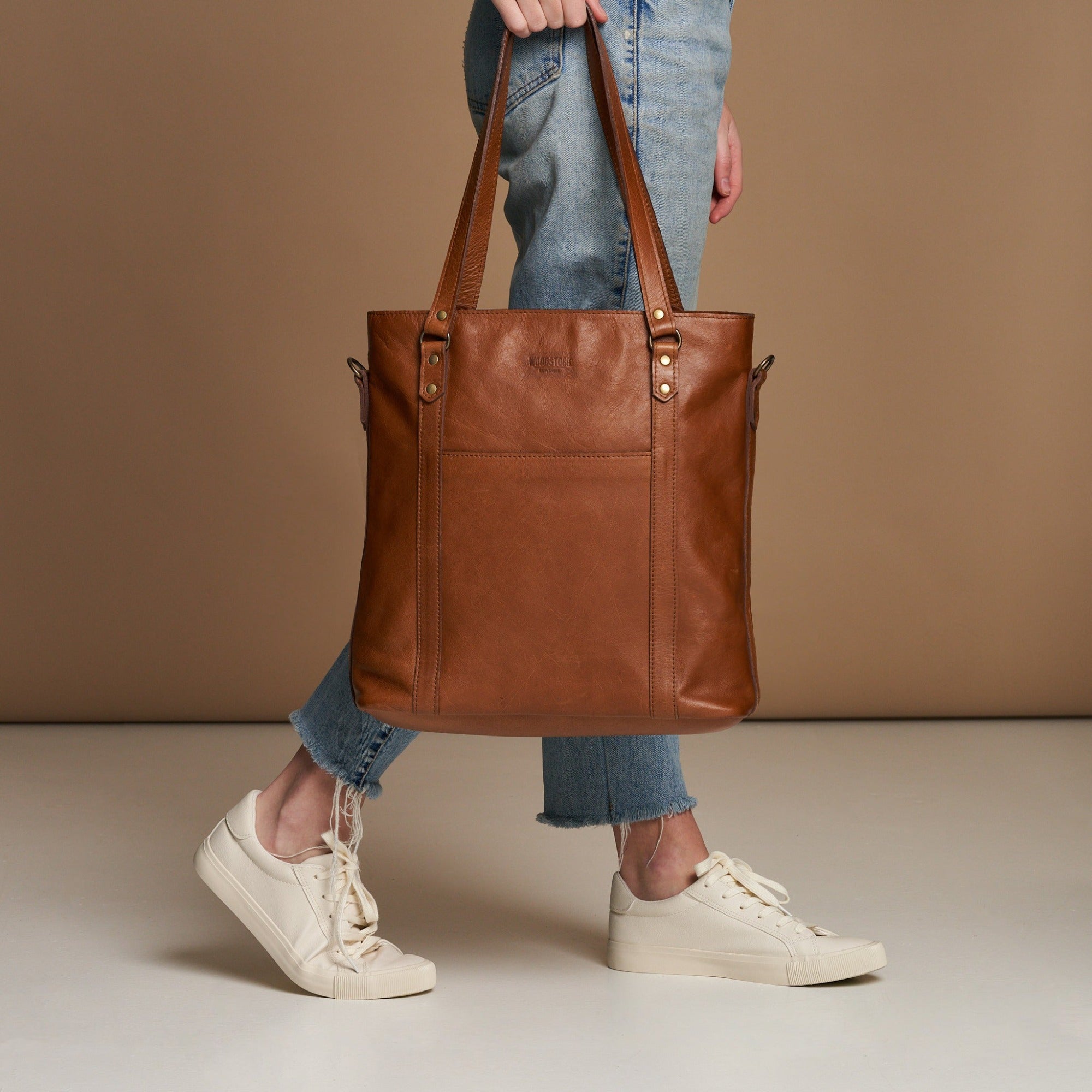 Model holding Pecan Genuine Leather Longline Essie Sling Handbag with Laptop Compartment | Woodstock Leather