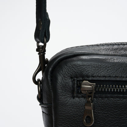 Closeup view of YKK zip and strap of Black Genuine Leather Madison Boxy Crossbody Sling Bag