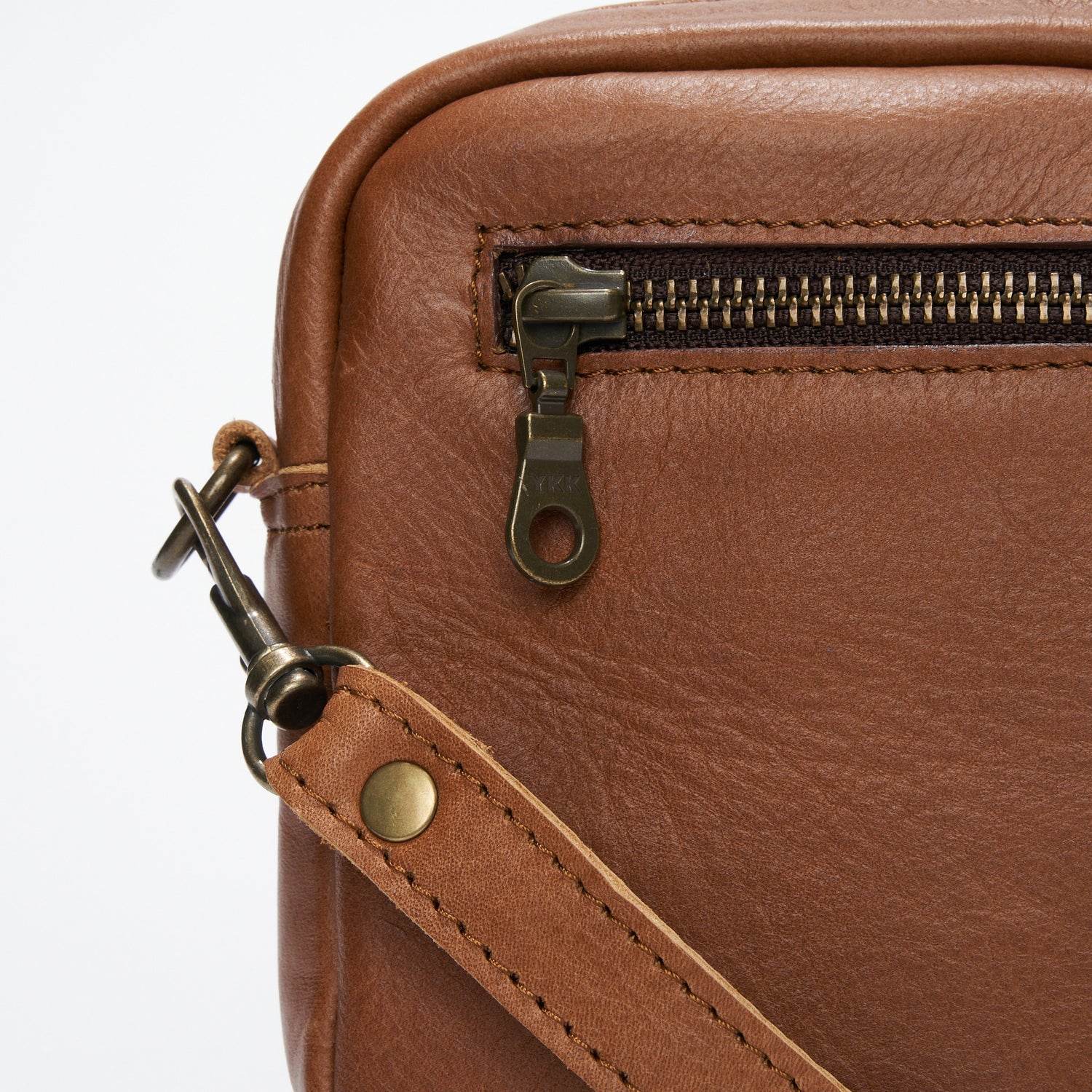 Closeup YKK zip and strap detail on Pecan Genuine Leather Madison Boxy Crossbody Sling Bag